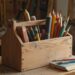 A wooden toolbox filled with various colored pencils and drawing tools rests on a wooden table in a workshop, reminiscent of the precision and creativity detailed in "How to Automate Classroom Tasks with AI Tools: A Practical Guide for Teachers.